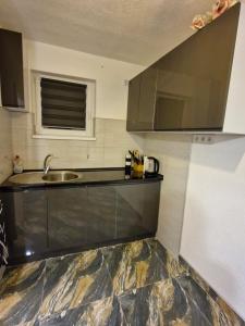 a kitchen with a sink and a counter top at Old Town Maglaj in Maglaj