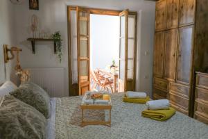 a room with a bed with a table and aoire at White Memories boutique home - Romantic Stay in Afandou in Afantou