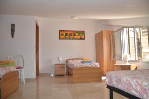 Ένα ή περισσότερα κρεβάτια σε δωμάτιο στο Taormina Bay Lucia's House 4