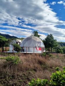 a domed building on top of a field at Hospedaje Mafer in Guatavita