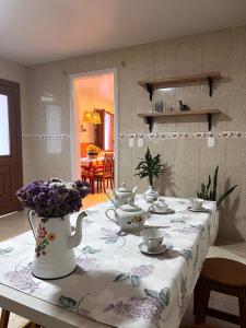 a table with a tea set on top of it at Casa Nona Chema in Bento Gonçalves