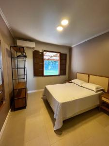 a bedroom with a bed and a window at Casa Nona Chema in Bento Gonçalves