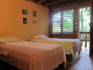 A bed or beds in a room at Hotel Chillies and Native Sons Diving
