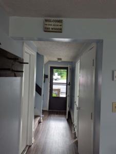 a hallway with a sign that reads welcome to the new house at Briarcliff C11 Condo in Sugar Mountain