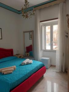 a bedroom with a bed with a mirror and a window at palazzo sardanelli camera in Pizzo
