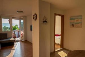 a living room with a view of a balcony at SUNSET Villa Apartments in Ohrid