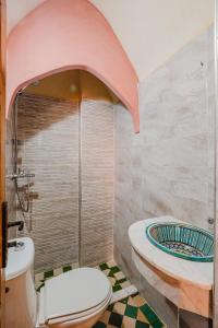 a bathroom with a toilet and a tub at Riad Mazouz102 Médina in Marrakech