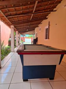 a pool table in the middle of a patio at Casa em Paracuru a 5 minutos (de carro) do centro. in Paracuru
