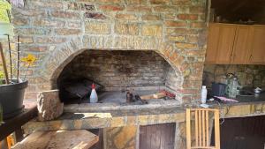 an outdoor brick oven with a stone wall at Guest House Skakavac in Sarajevo +11 photos