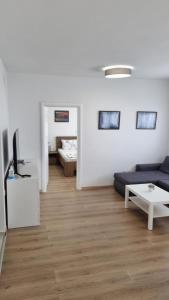 a living room with a couch and a table at Damir A4 in Selce