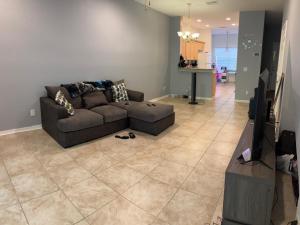 a living room with a couch and a flat screen tv at Townhouse Retreat in Riverview