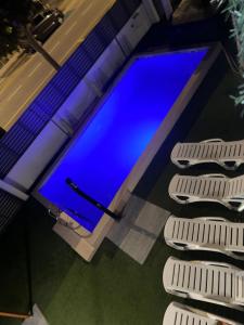 a swimming pool with blue water in a building at REQUESENS Playa in Empuriabrava