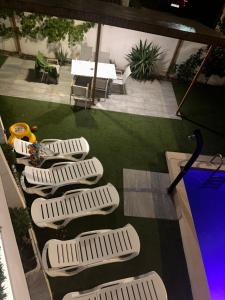 a view of a patio with four white chairs and a table at REQUESENS Playa in Empuriabrava