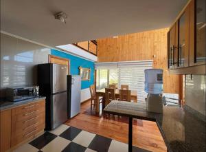a kitchen with a refrigerator and a table in it at Pedal Paradise Tongoy in Tongoy