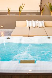 卡波圣卢卡斯Amazing 2 Bdrm condo near medano beach的带沙发的酒店客房内的热水浴池