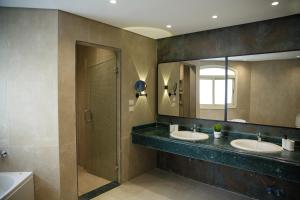 a bathroom with two sinks and a mirror at Munir`s residence 3 in Cairo +290 photos