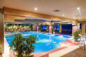 a large swimming pool in a hotel at Millo Apartament in Bucharest