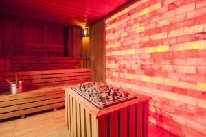 a room with a brick wall and a red heater at Millo Apartament in Bucharest