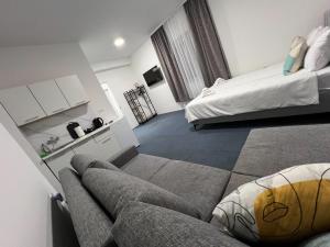 a living room with a couch and a bed at Urban Heart Residence in Sarajevo