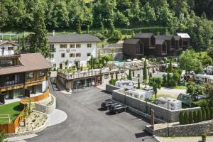 an aerial view of a resort with a parking lot at Hotel Ansitz Gamp in Chiusa