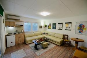 a living room with a couch and a table at SOKO Guesthouse & Garden in Skopje