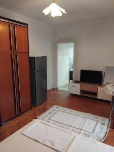 a living room with a refrigerator and a couch at Apartments Maki 1 in Tivat