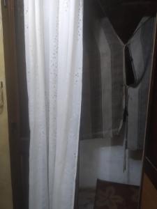 a white curtain is hanging in a room at Affordable downtown studio steps to sea free wifi in Alexandria +11 photos