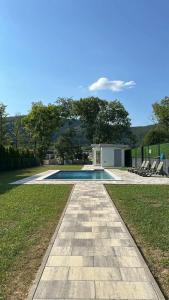 a walkway leading to a pool in a yard at Villa L&M in Bihać +19 photos