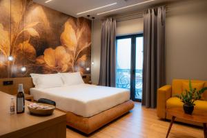 a hotel room with a bed and a chair at Ode Aristofanous - Urban Boutique Hotel in Athens