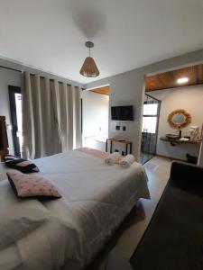 a bedroom with a large bed in a room at Pousada Kirana in Praia do Rosa +91 photos