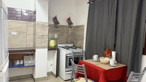 a small kitchen with a table and a stove at Altos del Norte - Salta la Linda ! in Salta +20 photos
