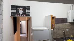 a small kitchen with a refrigerator and a sink at Altos del Norte - Salta la Linda ! in Salta