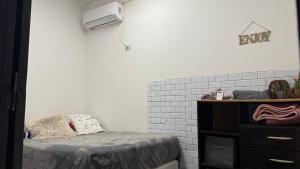 a bedroom with a bed and a dresser with a tv at Altos del Norte - Salta la Linda ! in Salta