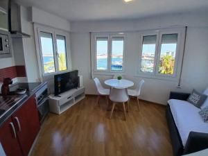 a small living room with a table and a couch at Port PENTHOUSE in Tarragona