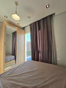a bedroom with a bed and a large window at Luxury chalet in Porto Golf for rent in El Alamein +21 photos