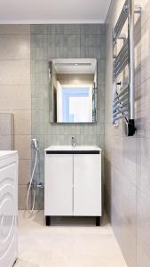 a bathroom with a white sink and a mirror at 104 - Beachside Renovated 1BR apt 5 min from Beach in Cambrils