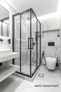a bathroom with a glass shower and a toilet at Azure Bliss in Nikiti +42 photos