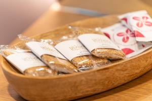 a wooden bowl filled with bagels on a table at Ode Aristofanous - Urban Boutique Hotel in Athens