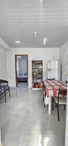 a living room with a table and a refrigerator at recanto provetá ILHA GRANDE in Praia de Provetá 