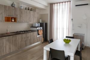 a kitchen with a white table and a white counter top at La Casetta in Reggio di Calabria