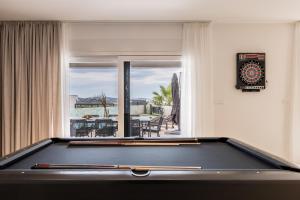 a pool table in a living room with a view at Villa Azzura in Vodice