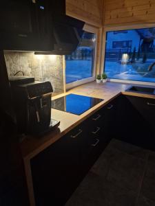 a kitchen with a coffee maker on a counter at OlszeVita in Szteklin