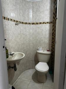 a bathroom with a toilet and a sink at Coliving habitacional in Cali +24 photos