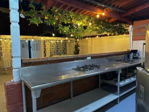 a kitchen with a counter with a stove at Coliving habitacional in Cali
