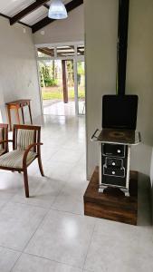 a living room with a stove with a tv on it at Casa no Bosque in Santa Cruz do Sul