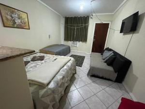 a room with two beds and a couch in it at Rua Lacerda sobrinho, 221 in Campos dos Goytacazes