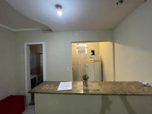 a kitchen with a counter top and a refrigerator at Rua Lacerda sobrinho, 221 in Campos dos Goytacazes