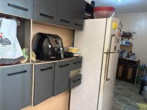 a kitchen with a white refrigerator in a room at casa para cop 30 in Belém +1 photo