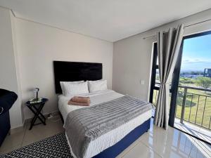Ένα ή περισσότερα κρεβάτια σε δωμάτιο στο The Millennial Charming cosy apartment , Umhlanga +17 φωτογραφίες