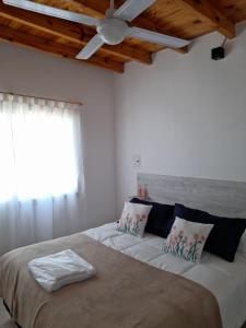 a bedroom with a large bed with a ceiling at Espectacular Duplex wine story Tupungato in Tupungato
